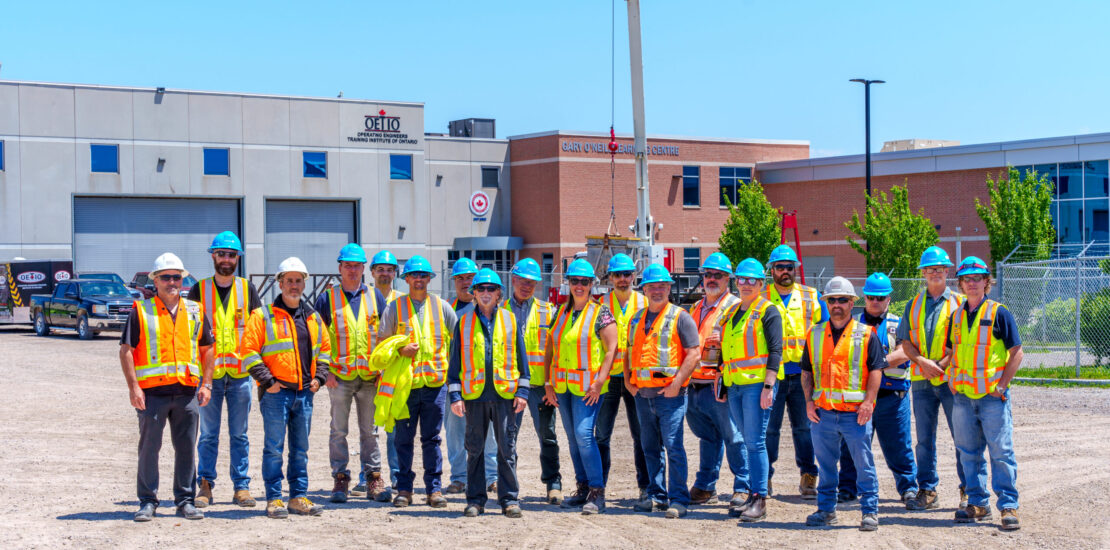 Ministry of Labour site visit with construction professionals wearing safety gear at an Ontario training facility